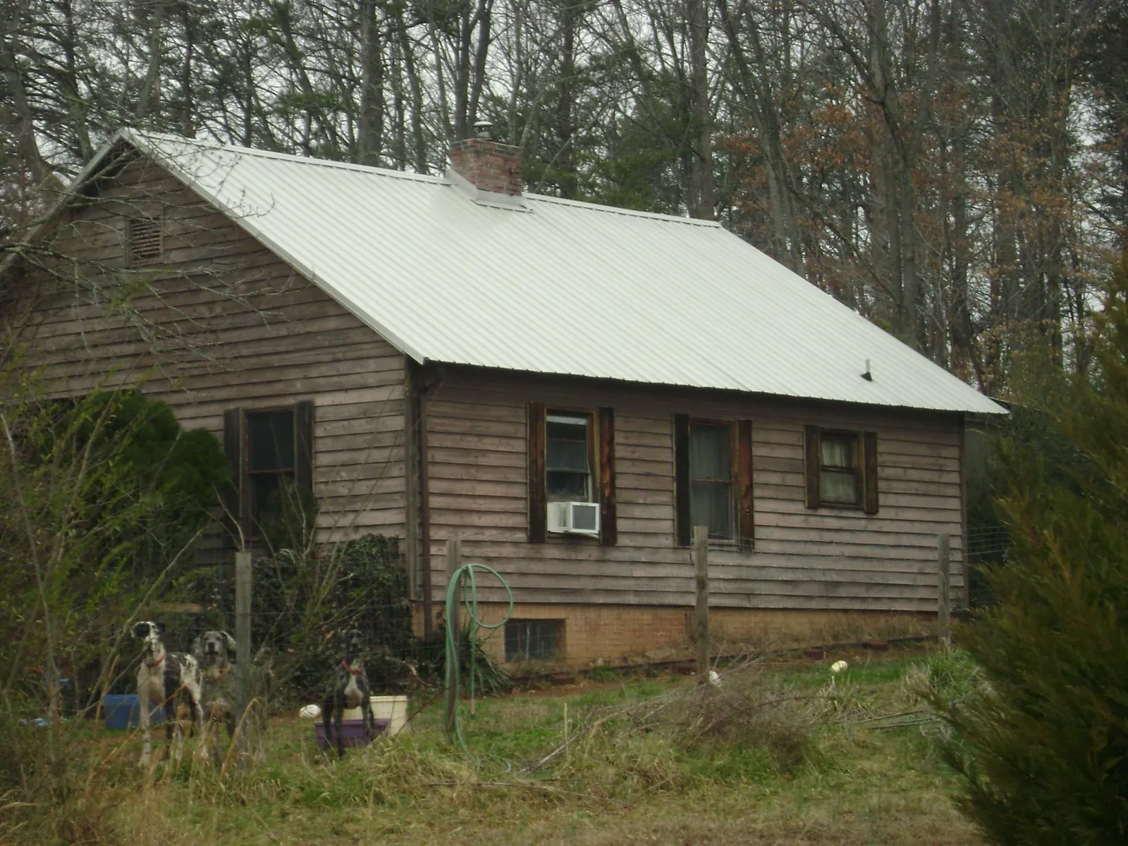 White metal roof on an old wood sided farmhouse, from a Metal Roof Installation job in Union Springs